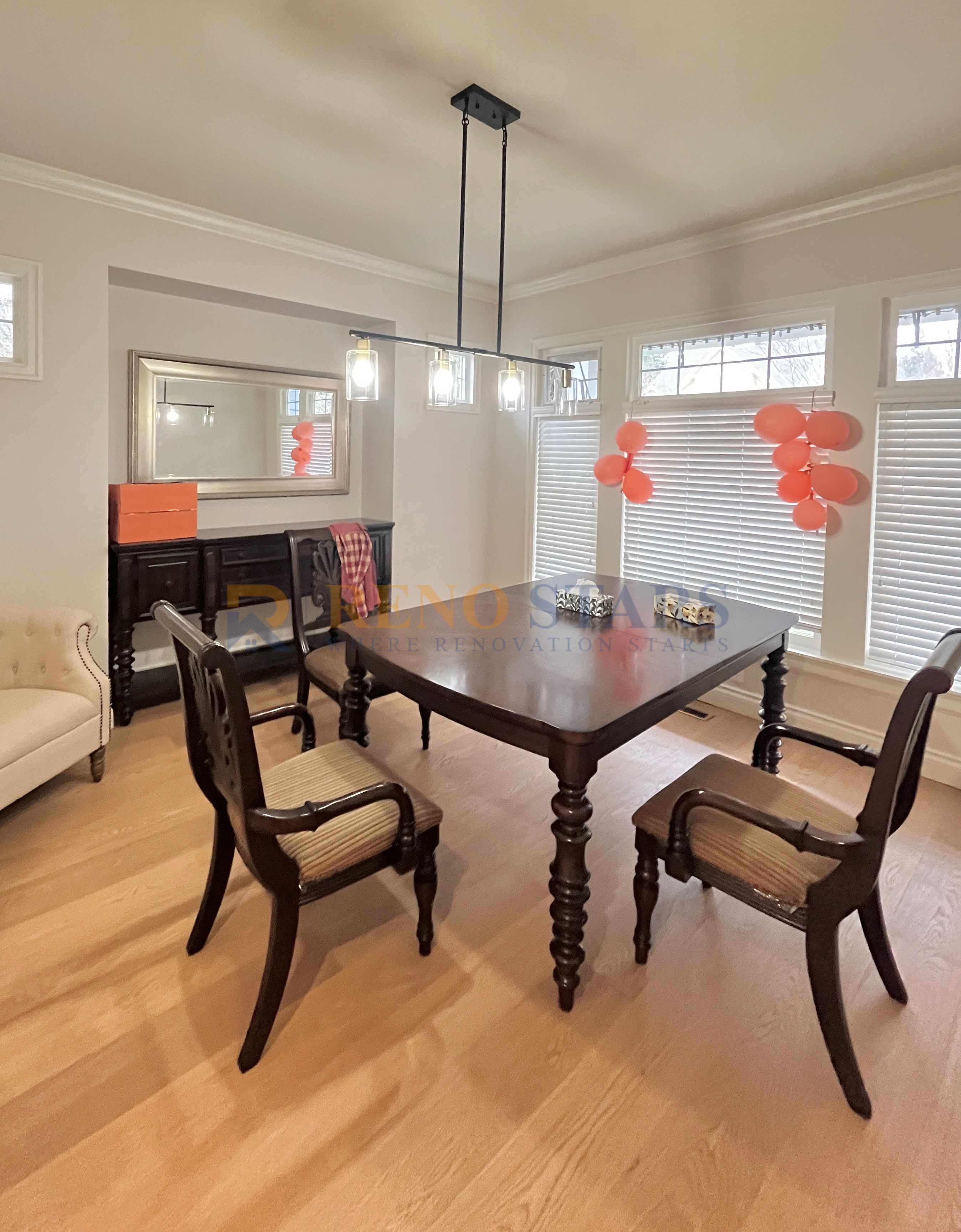 Elegant dining area featuring a wooden table, stylish chairs, and modern lighting.