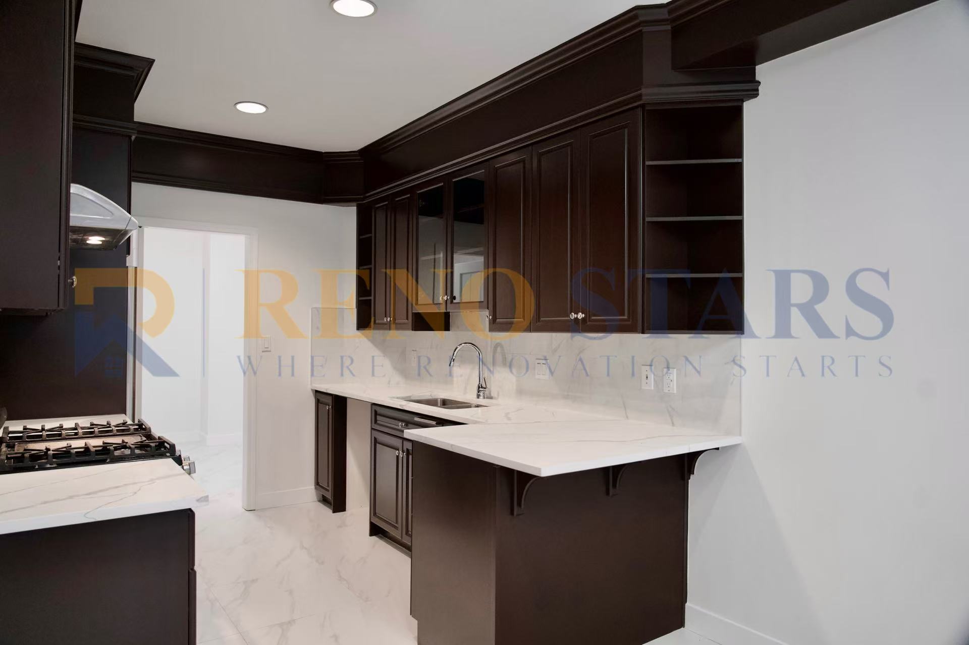 Modern kitchen featuring dark cabinetry and marble countertops with a sleek design.