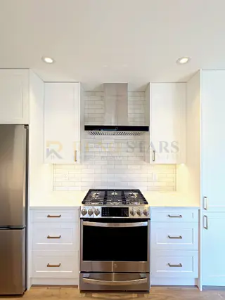 Kitchen Renovation with Apron Sink and Quartz Waterfall in Delta