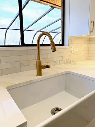 Kitchen Renovation with Apron Sink and Quartz Waterfall in Delta