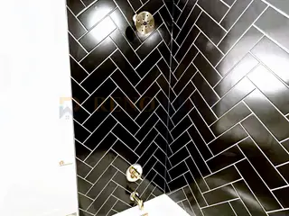 Bathroom Renovation with Black Herringbone Tile in North Vancouver