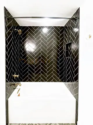 Bathroom Renovation with Black Herringbone Tile in North Vancouver