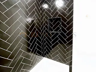 Bathroom Renovation with Black Herringbone Tile in North Vancouver