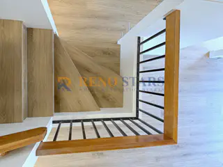 Rebuilt stairwell winder with LVP and black spindles