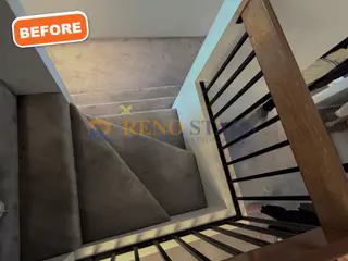 Worn carpeted stairwell before renovation