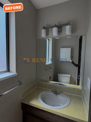 Dated powder room vanity before renovation