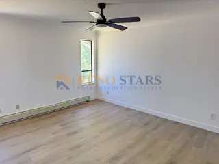 Bright bedroom with LVP flooring and smooth ceiling
