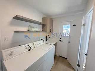 New laundry with shelving and LVP flooring